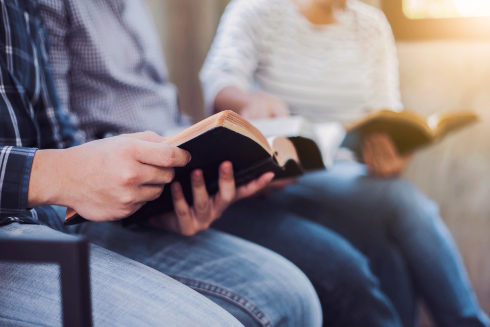 adults in drug rehab reading the bible as part of faith-based care