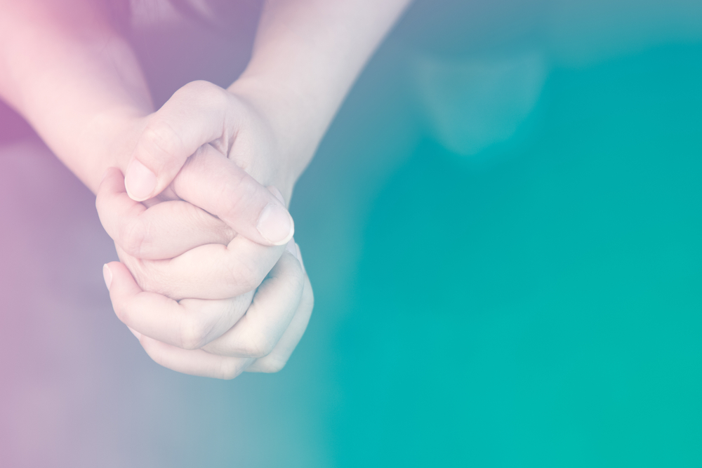 hands praying as part of faith based counseling