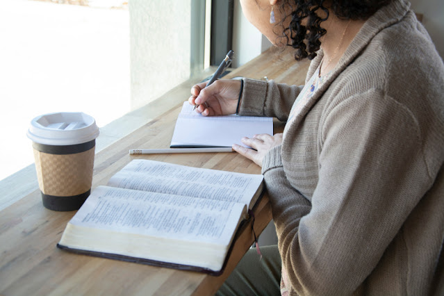 woman journaling and reading her Bible in Christian rehab